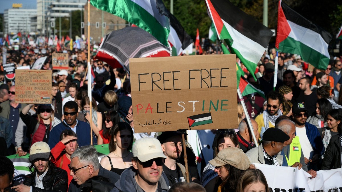 Participants march with a placard reading ‘Free Free Palestine’ during a demonstration under the motto ‘Draw the red line with us: Together for Gaza!’ in Berlin on September 27, 2025.