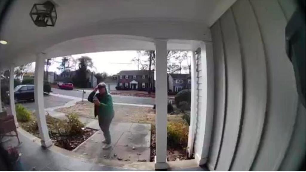 Protester Tova Fry takes photos of Dr. Glick's home 