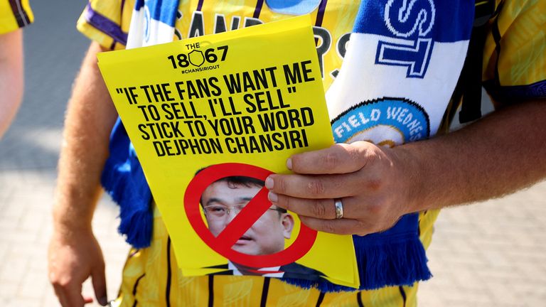 A Sheffield Wednesday fan holding a protest flyer. Pic: Reuters