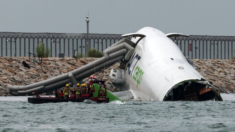 Escape slides were deployed and all four crew survived. Pic: Reuters