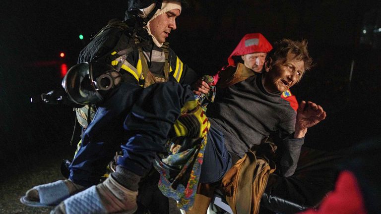 Rescuers carry an injured woman into an ambulance in Kyiv. Pic: AP