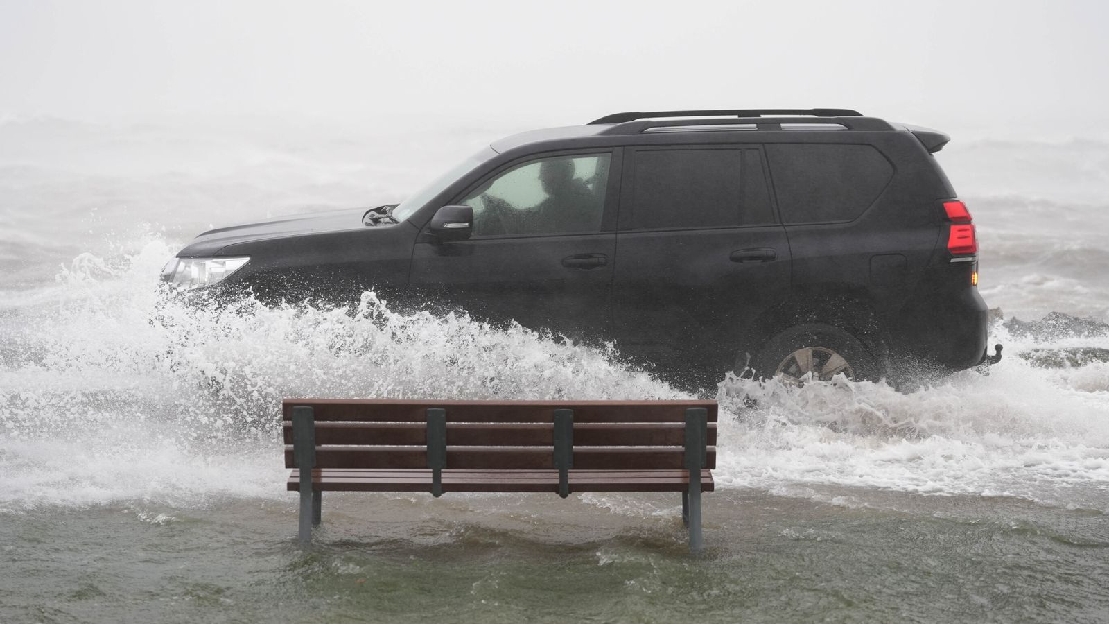 A car drives through floodwater in Galway, western Ireland. Pic: PA