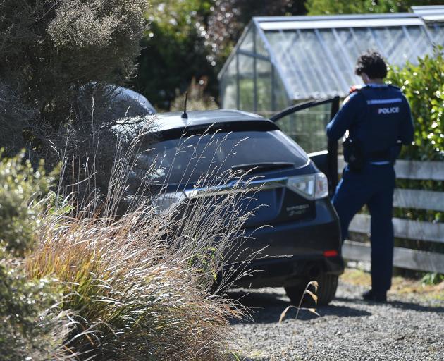 Police search a spiked car in Strawberry Ln, off Upper Junction Rd in Roseneath. PHOTO: GREGOR...
