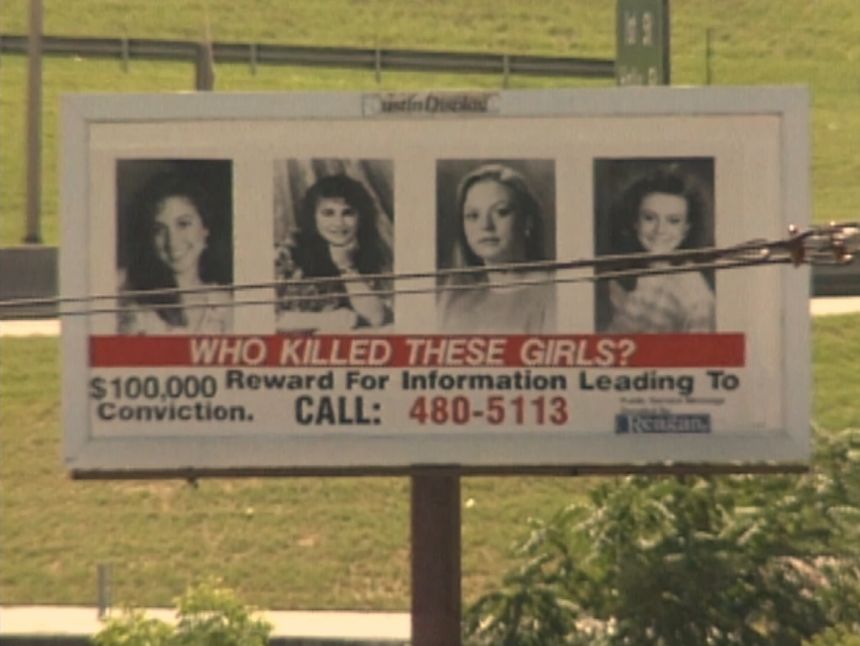 A billboard shows the photos of the four girls who were murdered at a yogurt shop in 1991.