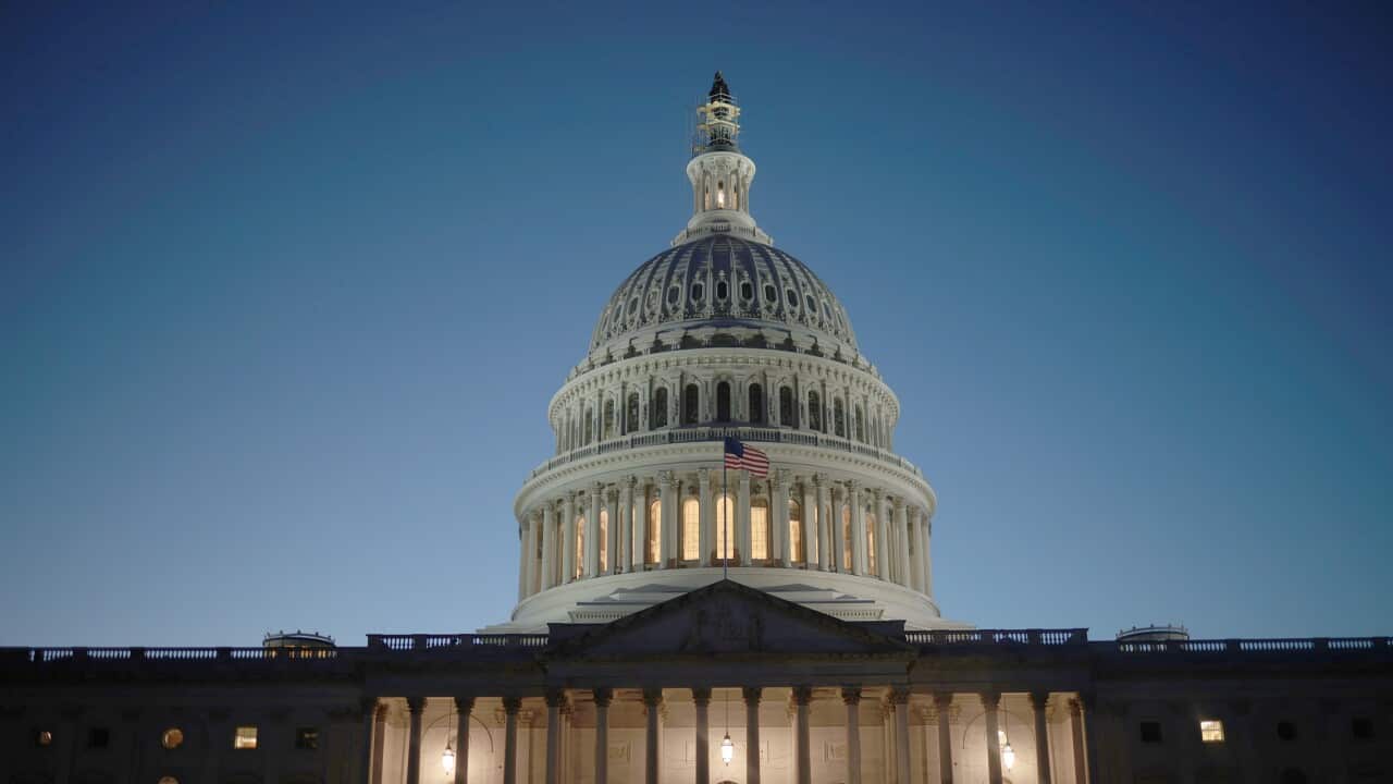 The US Capitol dome lit up at night.