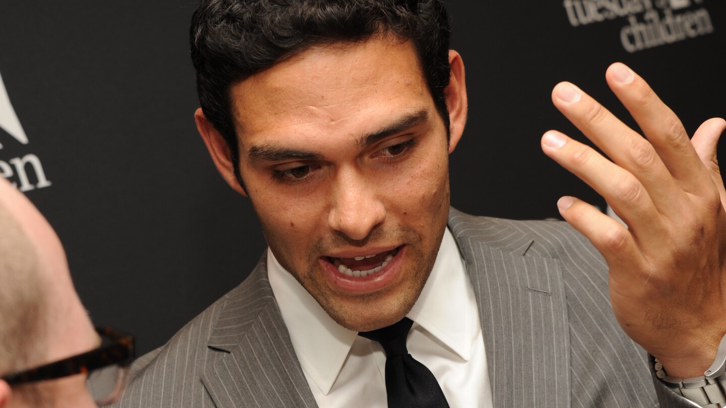Mark Sanchez speaks to reporter after formal booking