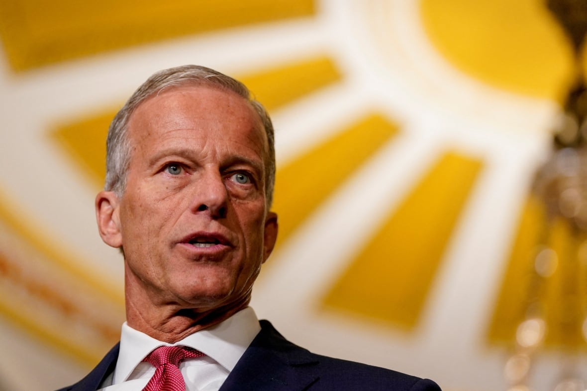 A man in a suit speaks