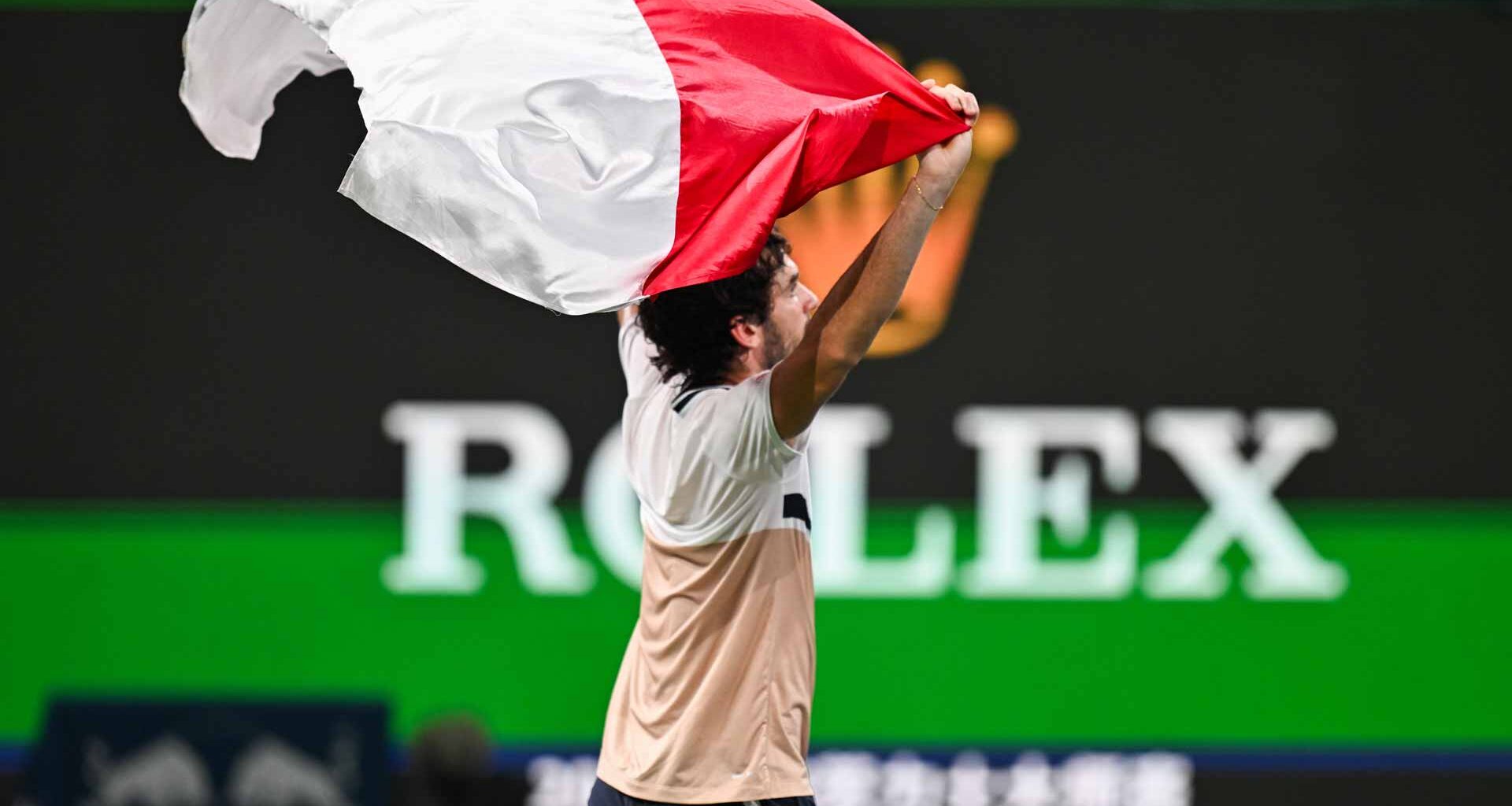 Valentin Vacherot celebrates his Shanghai title with the flag of Monaco, his home country.
