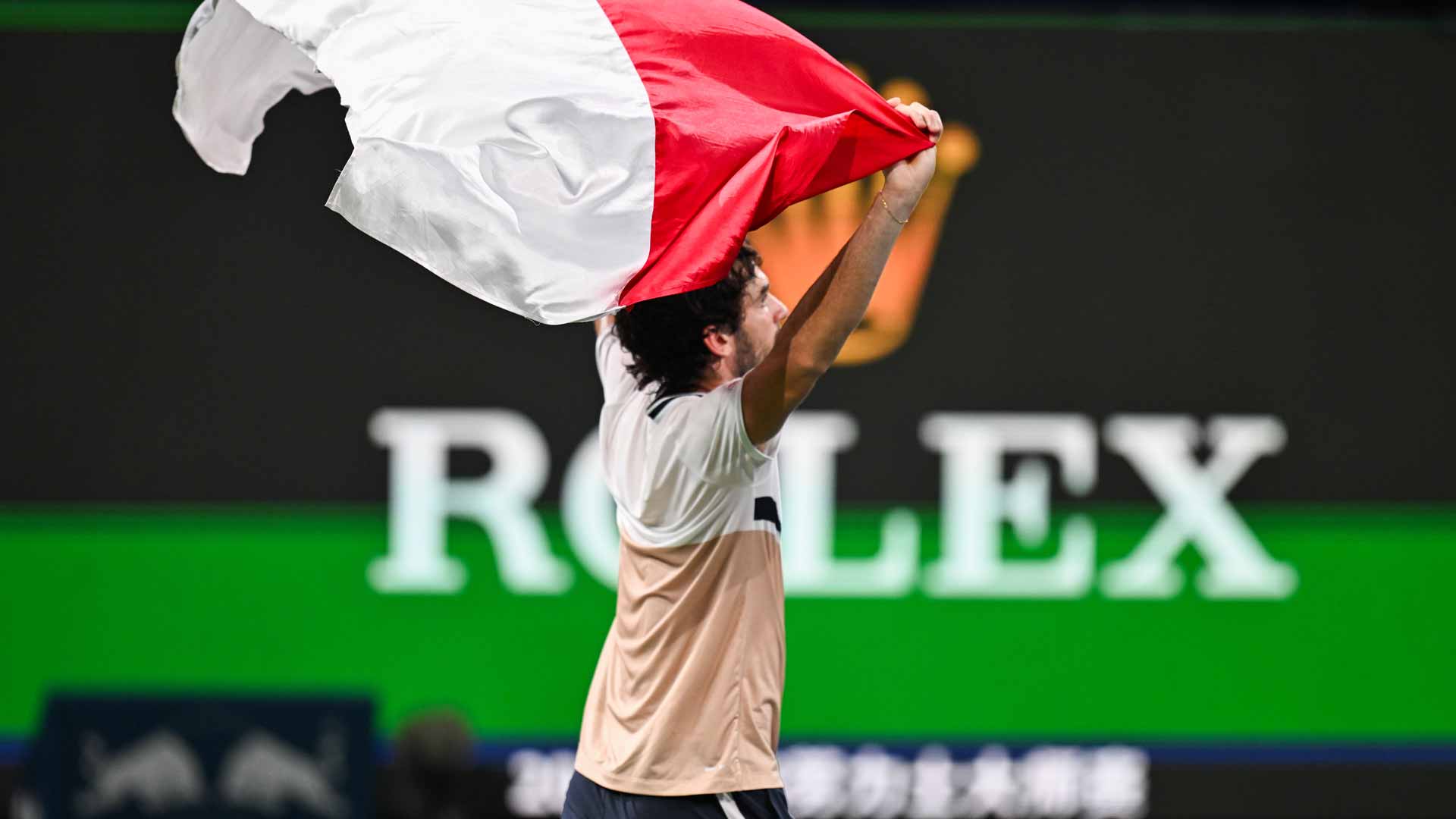 Valentin Vacherot celebrates his Shanghai title with the flag of Monaco, his home country.