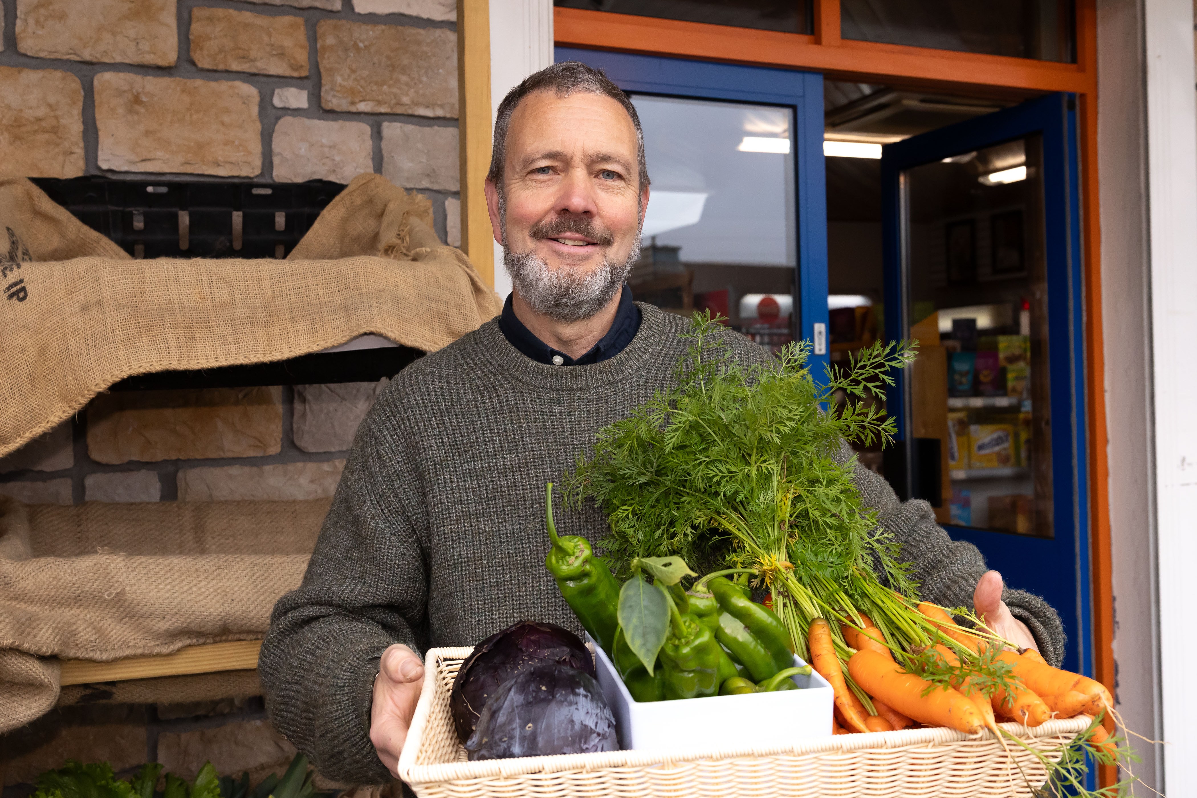 Hew Gregory-Smith holding a basket of fresh vegetables.