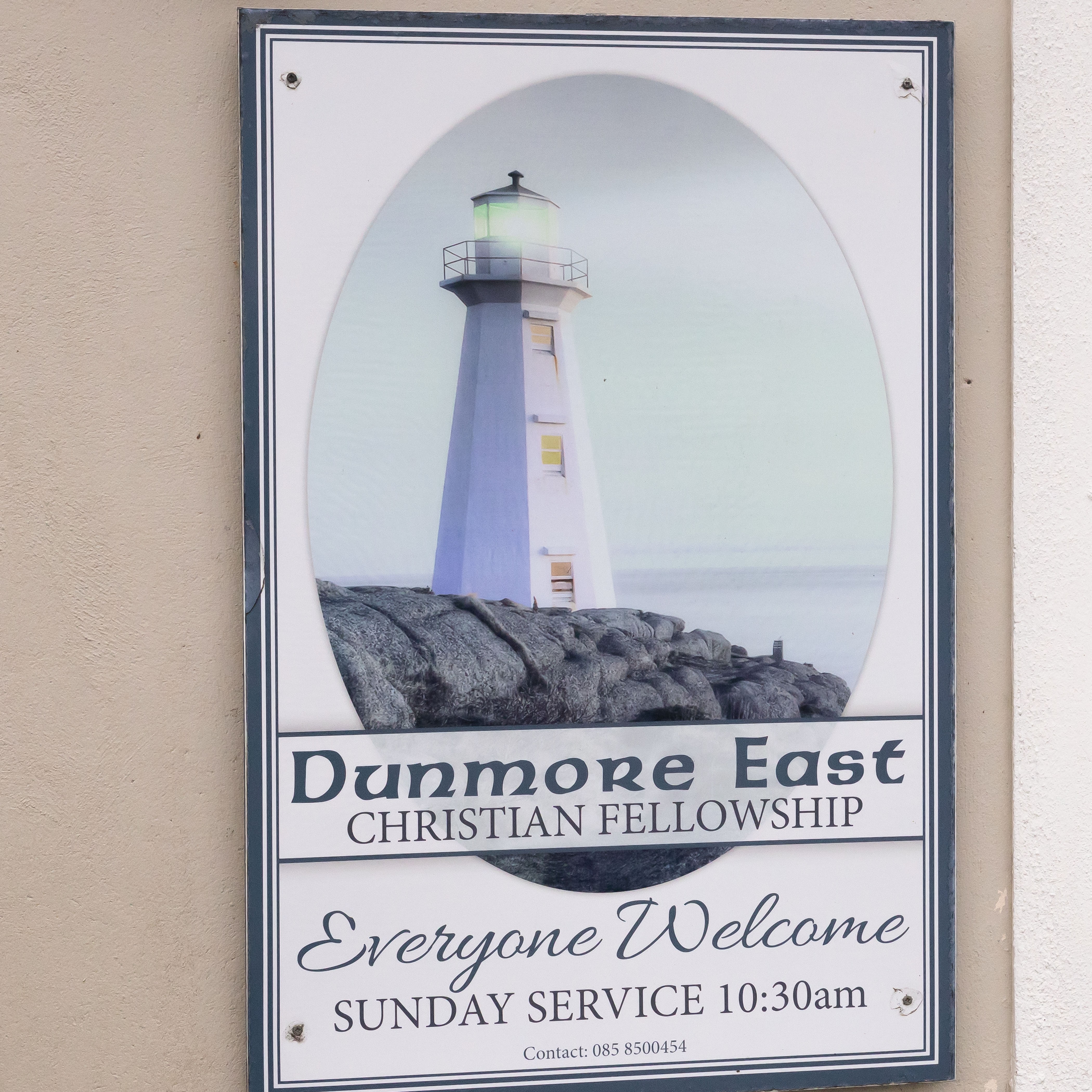 Sign for Dunmore East Christian Fellowship church with a lighthouse illustration.