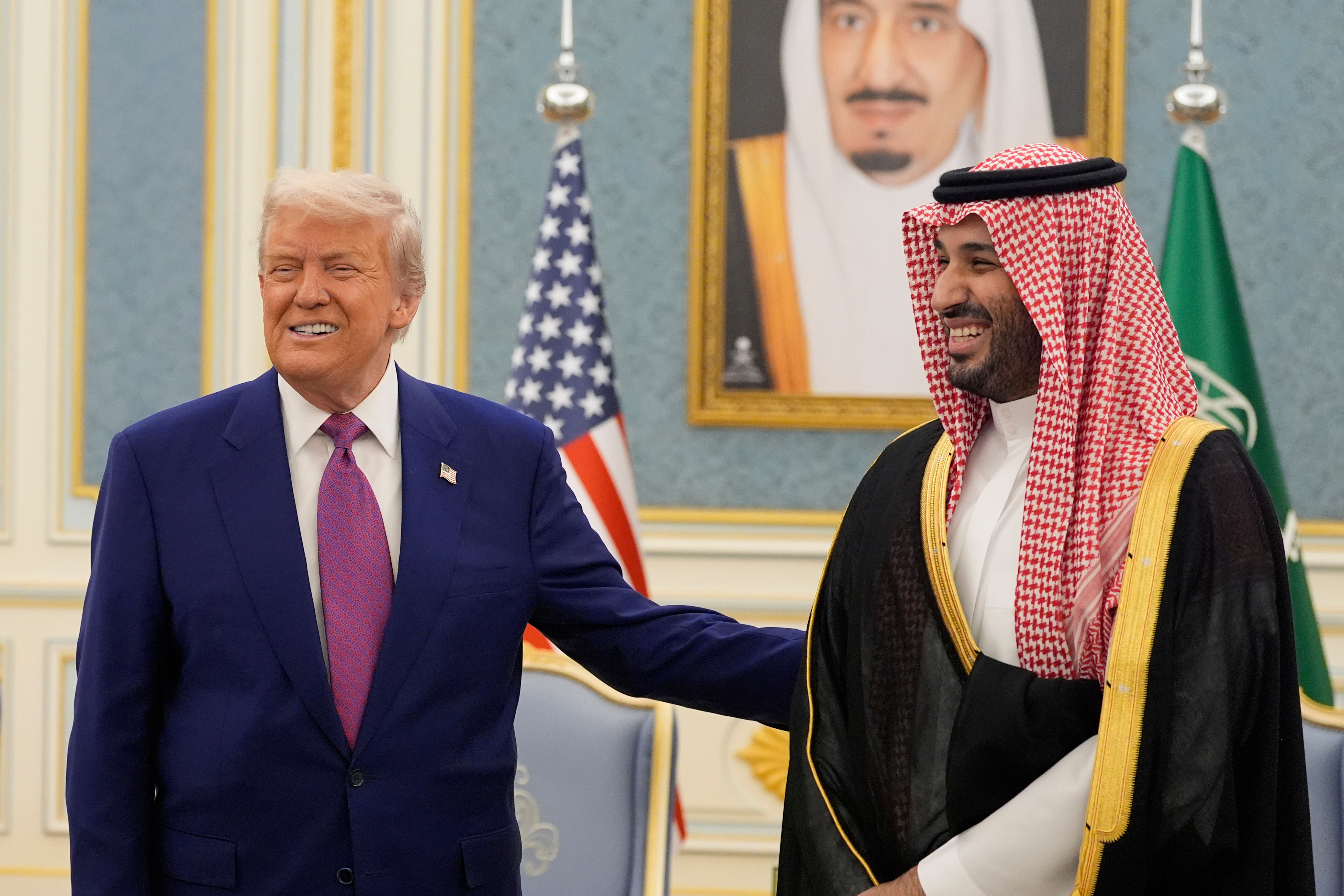 President Donald Trump and Saudi Crown Prince Mohammed bin Salman smiling while meeting delegations at the Royal Palace in Riyadh, Saudi Arabia.