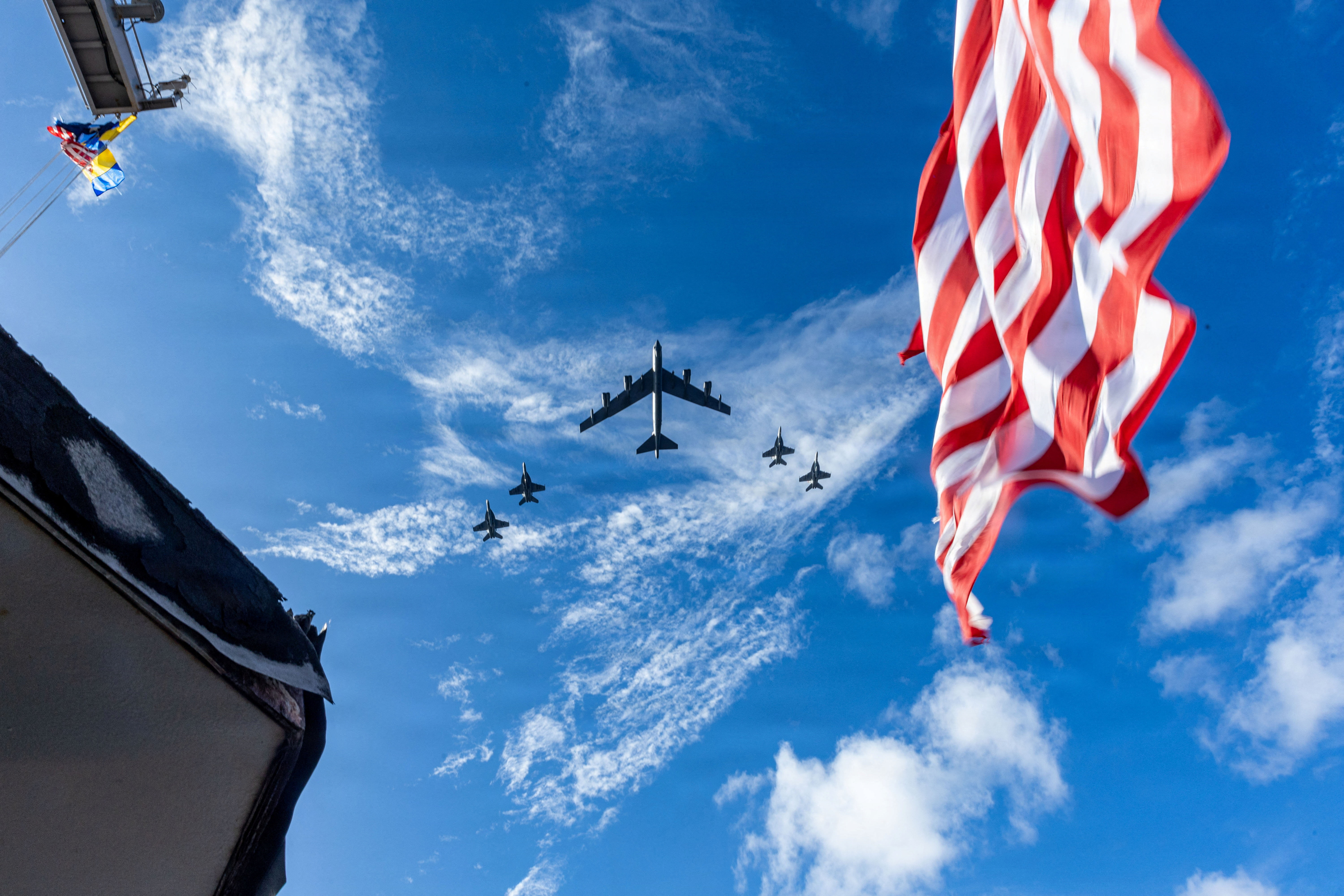 F/A-18E/F Super Hornets and a U.S. Air Force B-52 Stratofortress fly over the U.S. Navy’s Gerald R. Ford Carrier Strike Group.