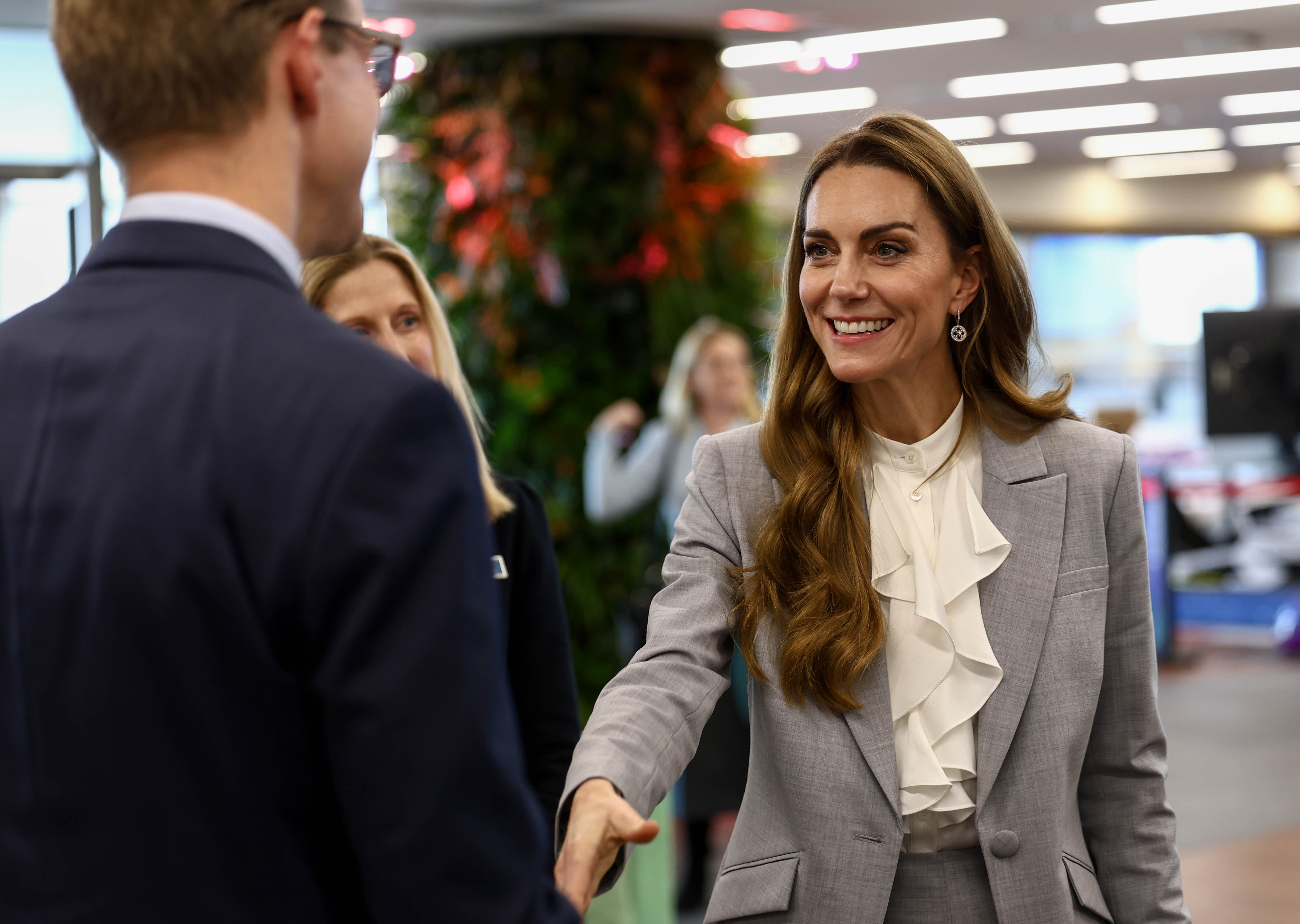 The Princess of Wales, Kate Middleton, smiling as she shakes hands with a man at the Future Workforce Summit.