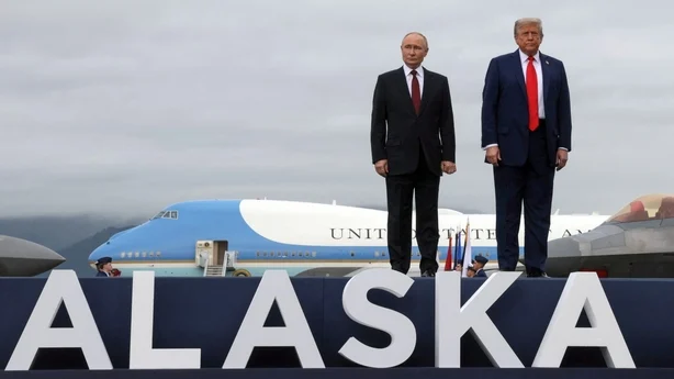 Vladimir Putin and Donald Trump pose for photos next to a sign for Alaska