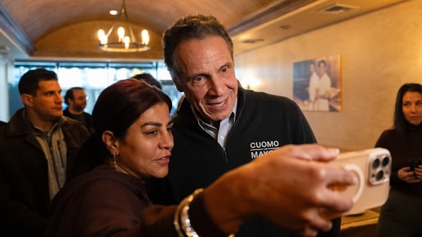 Andrew Cuomo takes a photo with a supporter 