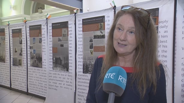 Historian Dr Fióna Gallagher standing behind on RTÉ microphone.