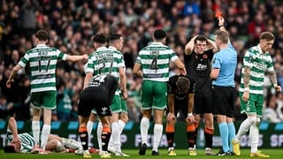 Harry Nevin of Cork City, right, is shown a red card by referee Paul Norton during the 2025 Sports Direct Men's FAI Cup Final match between Shamrock Rovers and Cork City at the Aviva Stadium in Dublin
