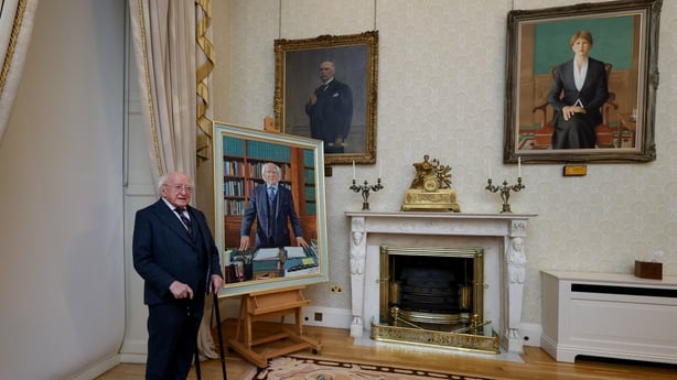 President Higgins stands alongside his portrait