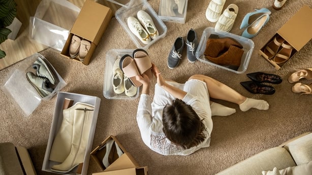 Woman packing shoes into PVC container and cardboard box 