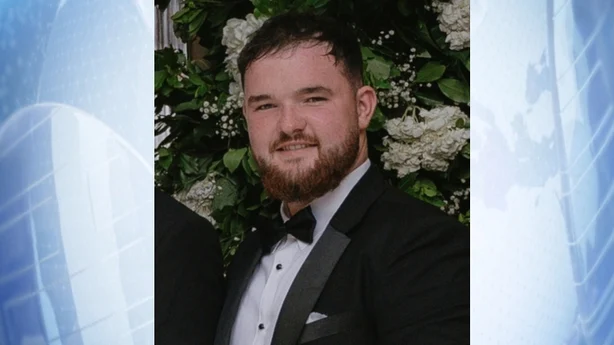 a photograph on a blue background of alan mccluskey