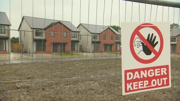 Photo shows Ringfort estate in Co Meath behind a metal fence with a 'Danger. Keep out' sign