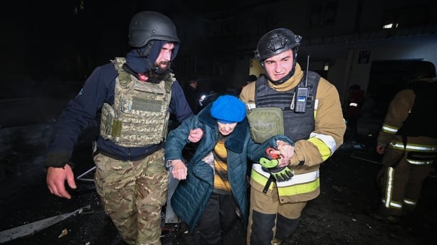 rescuers assist an elderly person