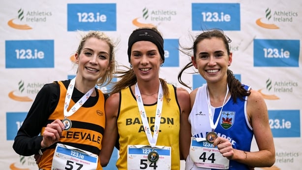 23 November 2025; The senior women's podium, from left, second place Niamh Allen of Leevale AC, Cork, race winner Fiona Everard of Bandon AC, Cork, and Danielle Donegan of Tullamore Harriers AC, Offaly, during the 123.ie National Cross Country Championships at Templemore Sports Complex in Derry. Pho