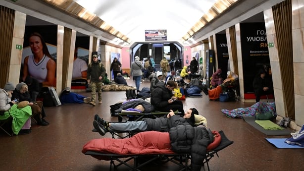 People take shelter at a metro station during an air attack in Kyiv 