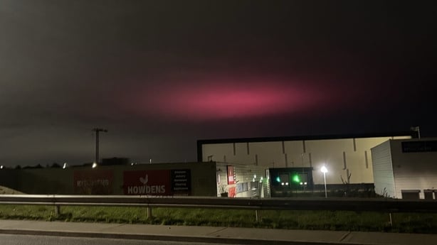 A pink light is seen over a building in Dublin