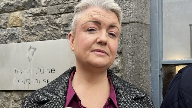 A woman stands outside a coroners court