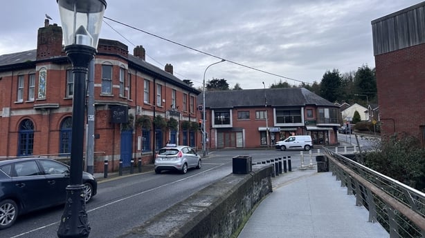 Cars pass through Chapelizod village.