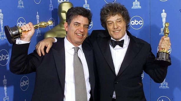 (L-R) Marc Norman and Tom Stoppard pose with their Oscars for Best Screenplay Written Directly for the Screen for Shakespeare in Love at the 71st Annual Academy Awards in Los Angeles, California in March 1999