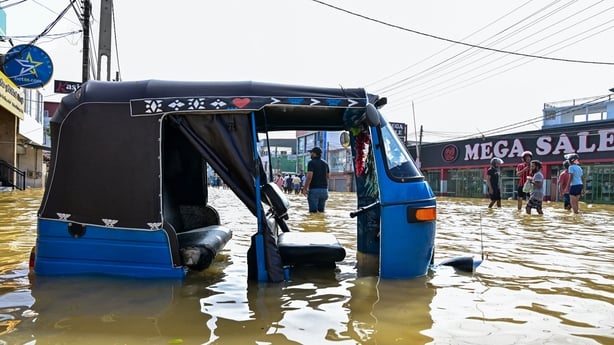 An auto rickshaw lies stranded in flood waters