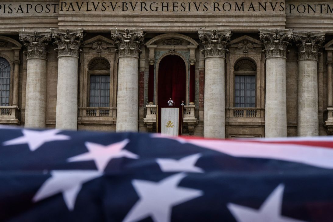 An American flag waves as Pope Leo delivers the Regina Caeli prayer from the main central loggia of Saint Peter's Basilica in May.