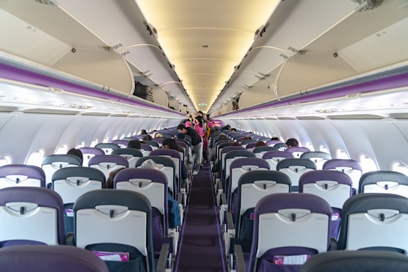 Inside an Airbus A320-200 aircraft cabin.
