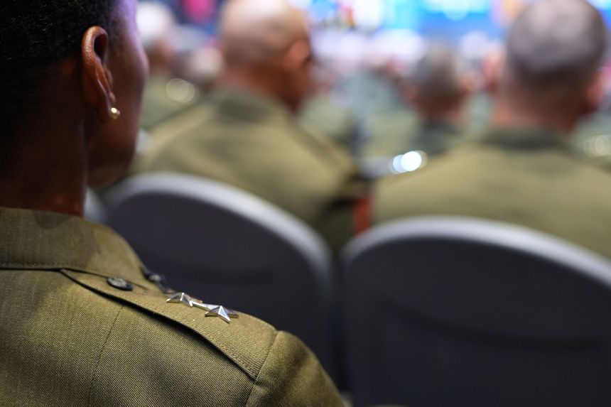A senior US military leader listens as President Donald Trump speaks at Marine Corps Base Quantico, on September 30.