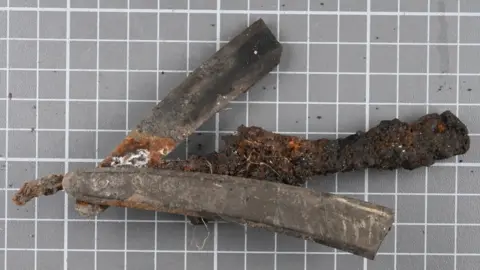 ODAIT A historic razor found during an excavation. It is brown and heavily rusted in places. 