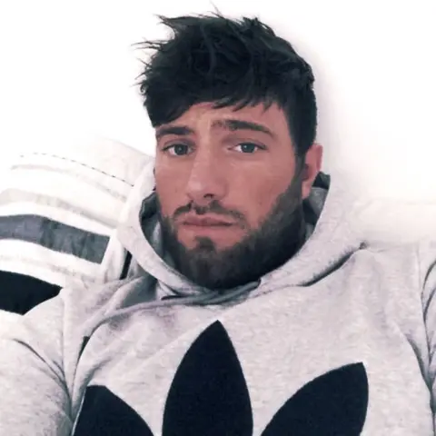 Instagram Harkins looking at the camera dressed in grey hoodie