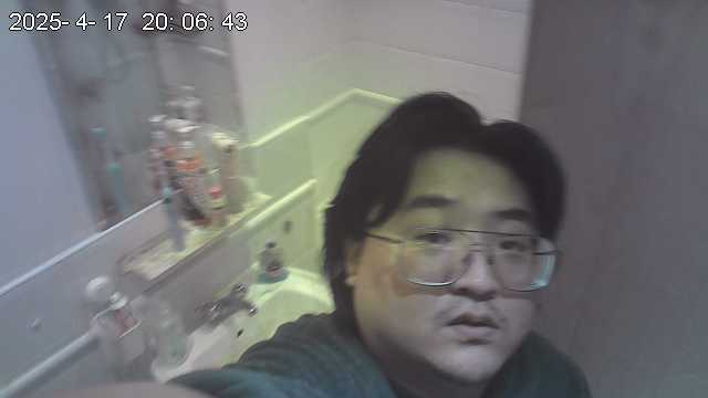 An image of Xu placing a hidden camera inside his bathroom