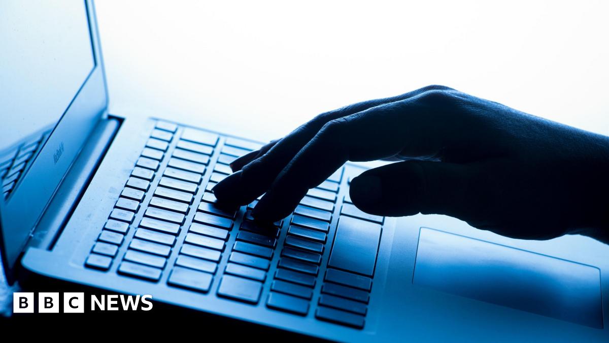 A stylised stock image of a laptop keyboard and a hand typing.