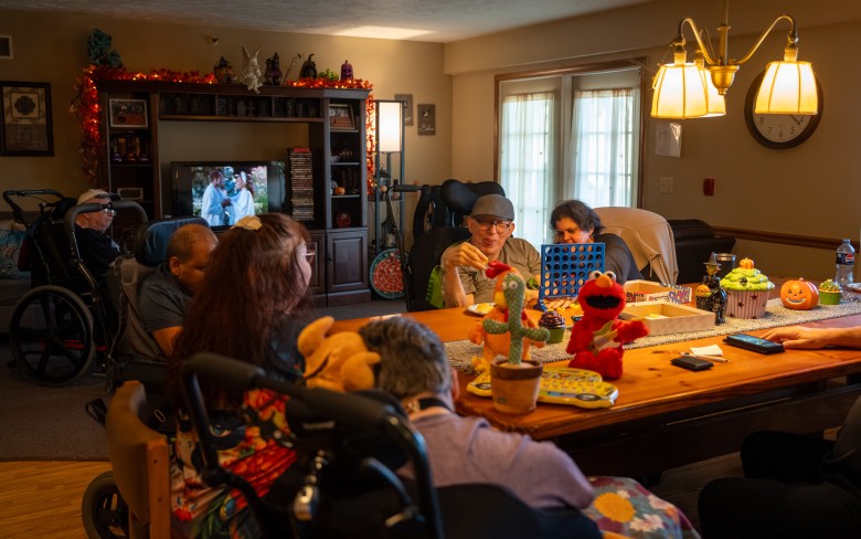 People sitting around a dining room. 