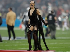 Singer Karina Pasian prepares to perform the U.S. national anthem before the NFL game between Miami Dolphins and Washington Commanders in Madrid, Spain.