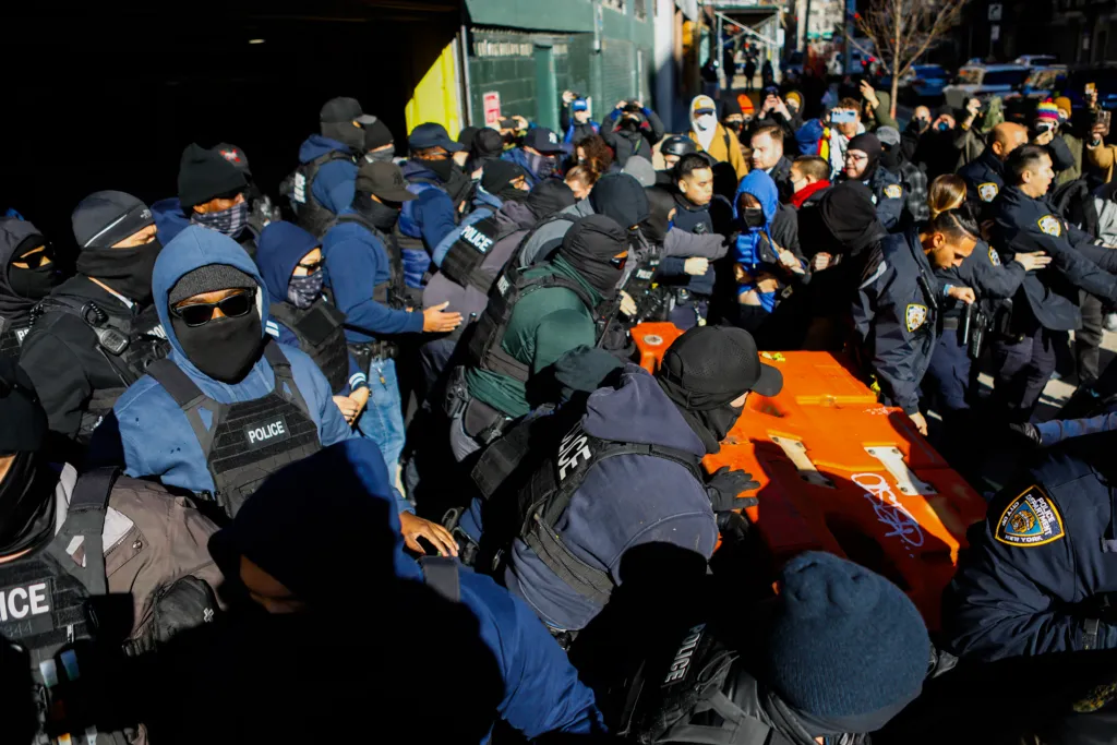 Federal agents clash with dozens of protesters outside a General Services Administration garage near Canal Street ahead of an expected immigration raid