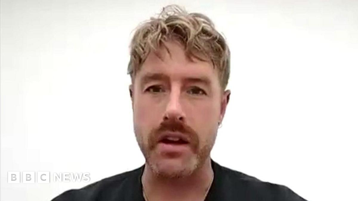 Picture of Victoria Bond, a woman with blonde hair wearing a black woolly hat, smiling at the camera