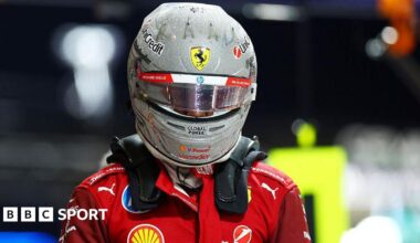 Lewis Hamilton, still wearing his race helmet, after getting out of his Ferrari having been eliminated in the first part of qualifying