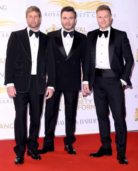 Getty Images Westlife posing in dinner jackets and bow ties