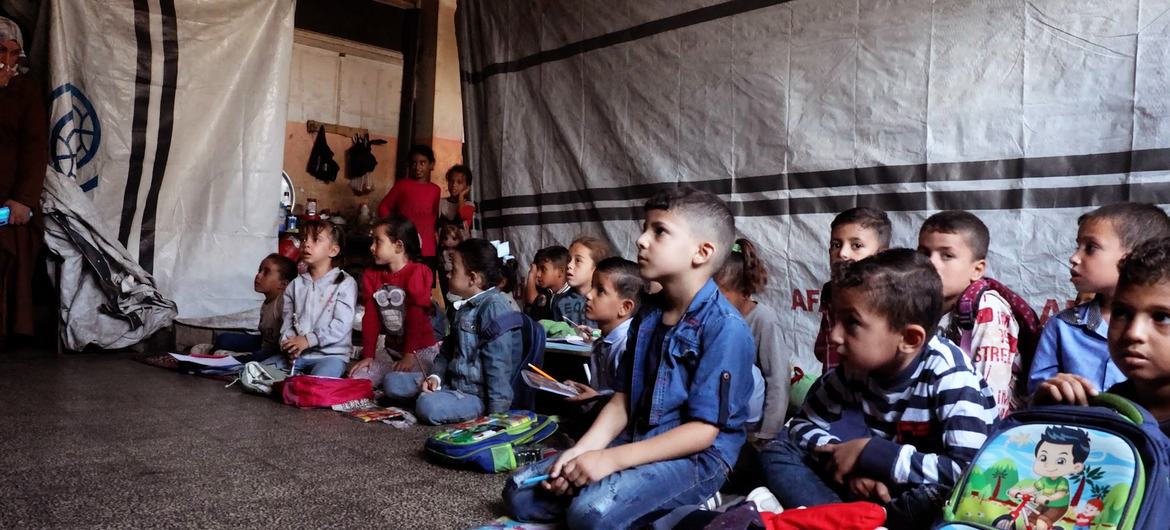 Students sitting on the floor while attending classes at Deir al-Balah Co-educational Primary School, run by UNRWA.
