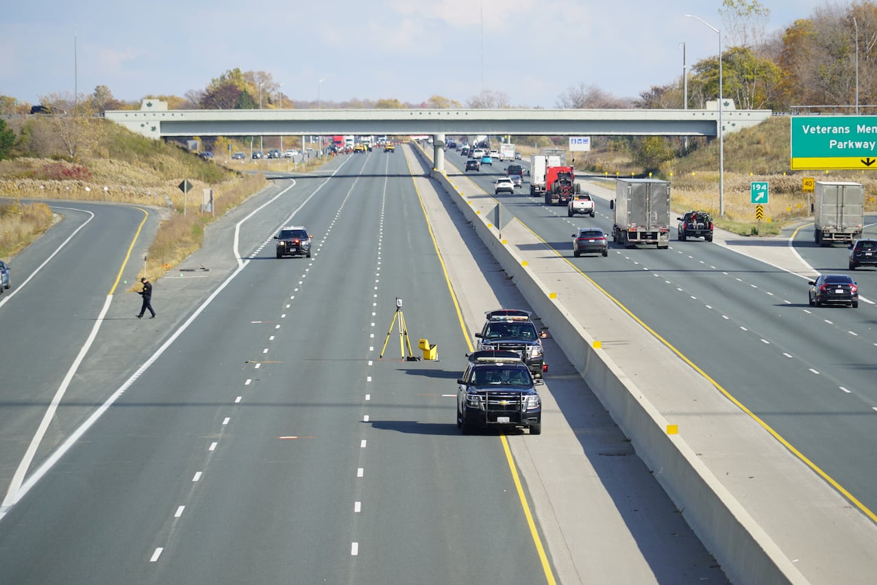 Police investigate the scene of the crash on Hwy. 401.