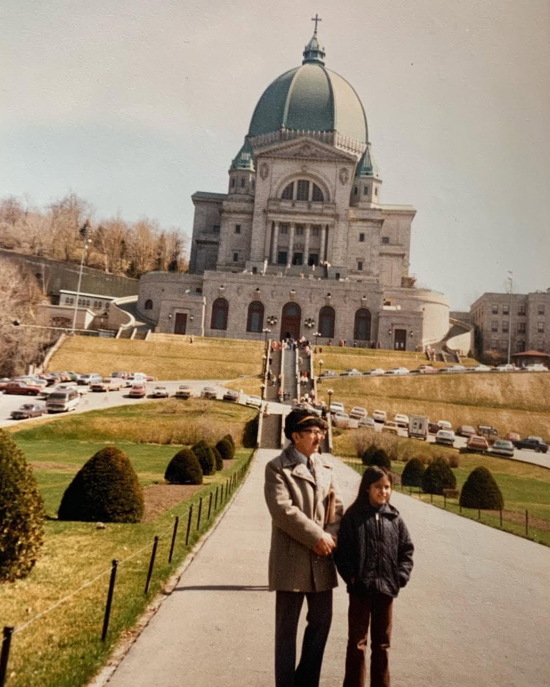 Soraya Martinez Ferrada, age eight, with her grandfather standing before Saint-Joseph's Oratory in Montreal. 